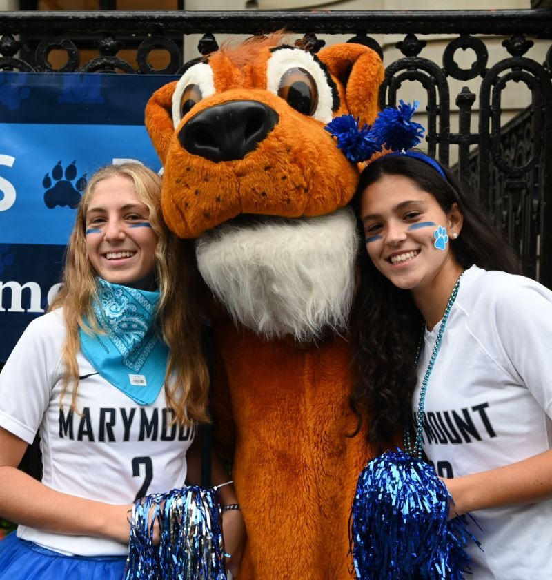two students in spirit wear with school mascott