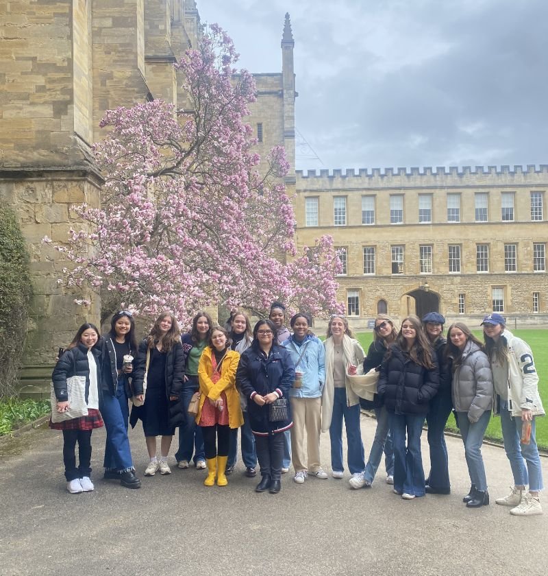 students posing in front of a castle