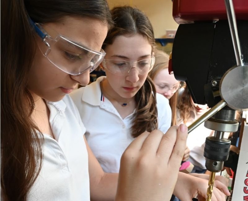 upper mid students using a drill