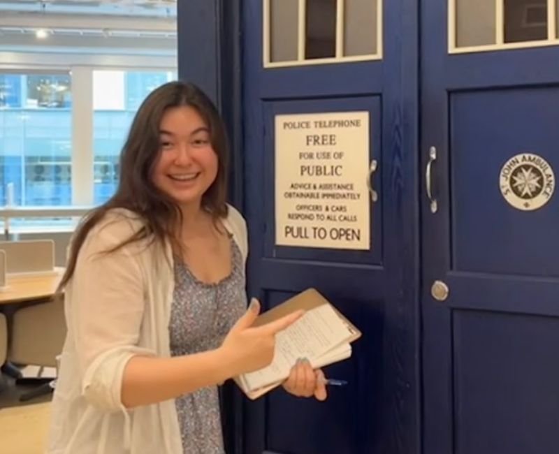 upper school student posing with a model TARDIS