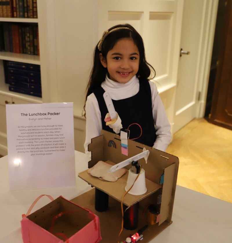 lower school student with homemade "lunch packer" robot