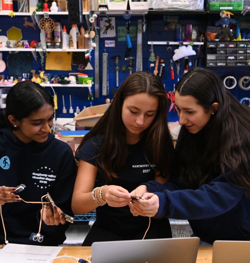 upper school students putting together robotic components