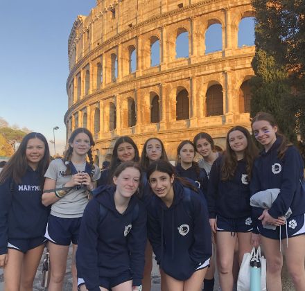 upper school students posing in front of the Colosseum 
