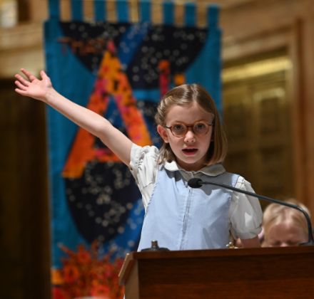 lower school student speaking at podium